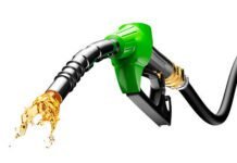 पेट्रोल डीजल के दाम हुए कम, Gasoline gushing out from pump isolated on white background